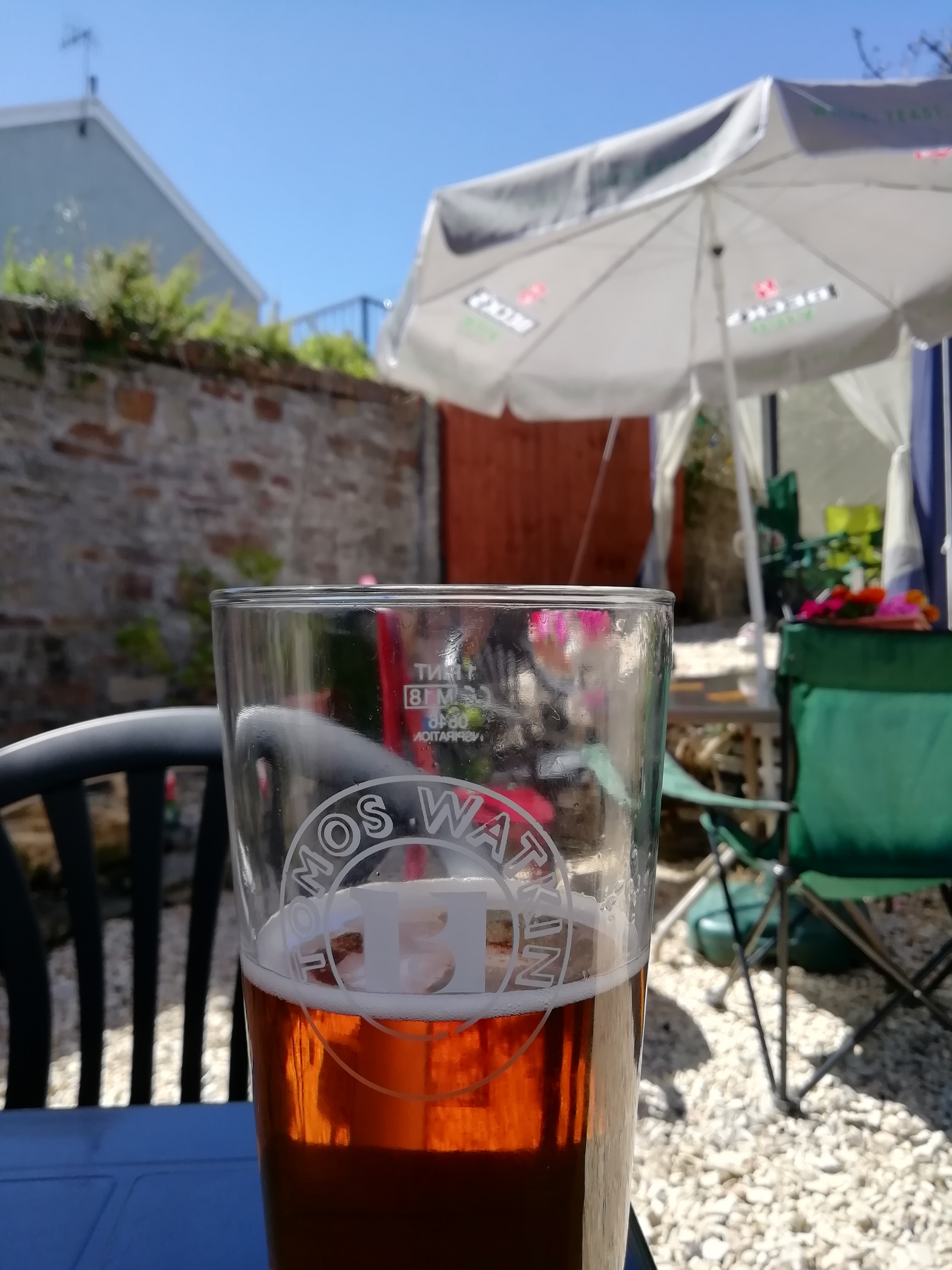 A beer, tables and parasols in the garden of the Wern Fawr